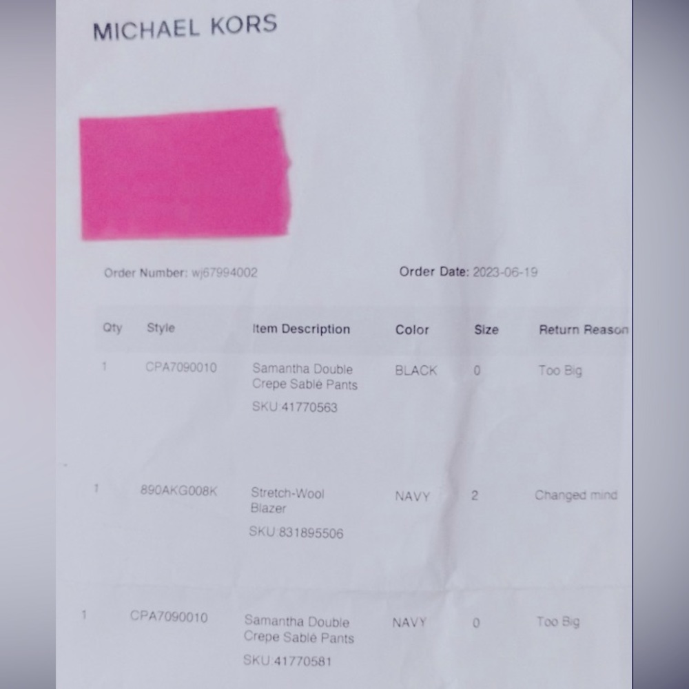 Michael Kors pantsuit tags still on.